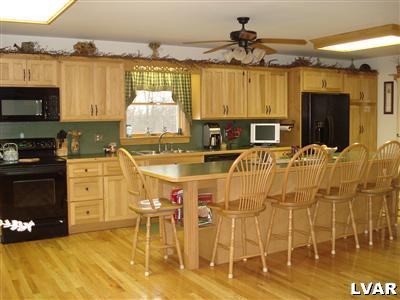 500 Point Phillips Road Bath, PA 18014 - Photo 2 of 31 a kitchen with stainless steel appliances kitchen island granite countertop a stove and a microwave