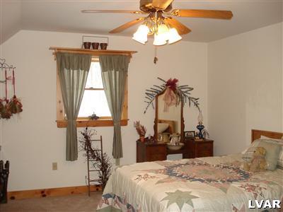 500 Point Phillips Road Bath, PA 18014 - Photo 22 of 31 a bedroom with a bed and a chandelier