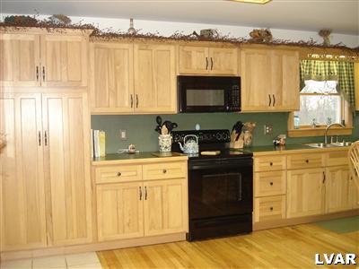 500 Point Phillips Road Bath, PA 18014 - Photo 7 of 31 a kitchen with stainless steel appliances granite countertop a stove a sink and a microwave
