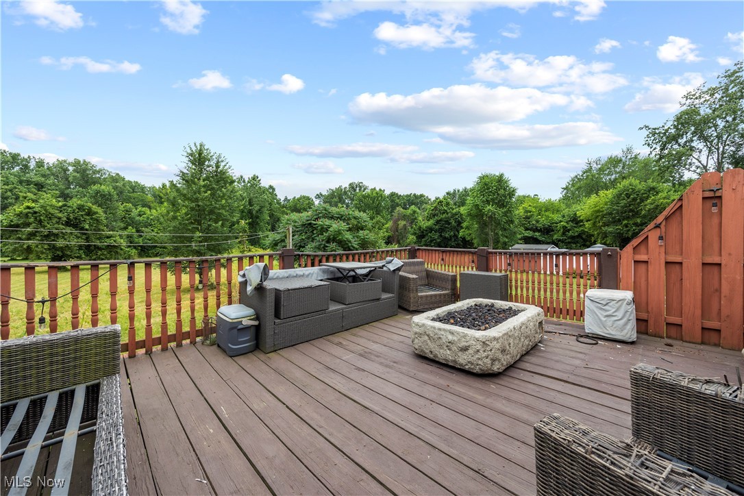 43995 Middle Ridge Road Lorain, OH 44053 - Photo 42 of 49 Wooden deck featuring an outdoor living space with a fire pit.