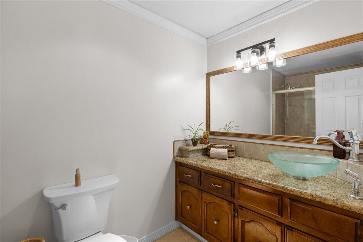 324 China Gulch Road Jacksonville, OR 97530 - Photo 28 of 45 a bathroom with a granite countertop sink a toilet and a mirror