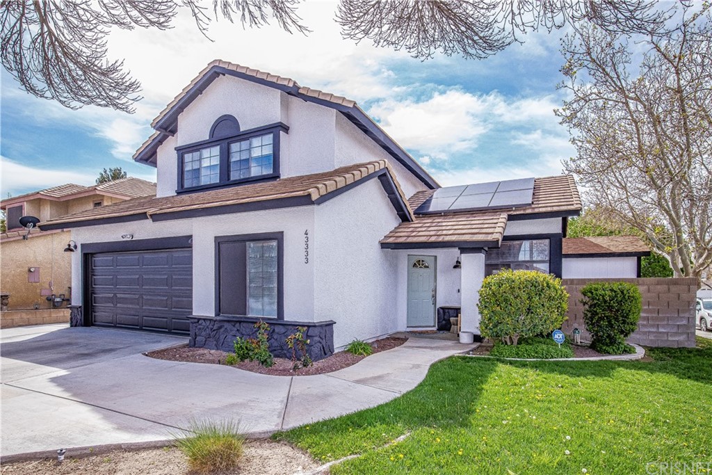 43333 Cottage Lane Lancaster, CA 93536 - Photo 1 of 1 a front view of a house with a garden and plants