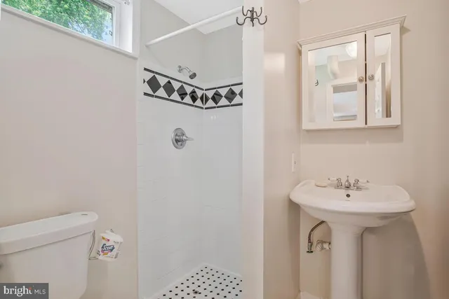 a bathroom with a sink a mirror and a shower