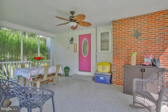 a dining room with furniture and a floor to ceiling window