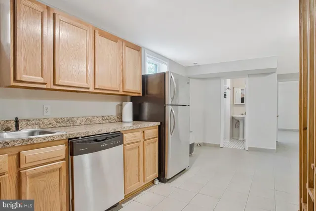a kitchen with a refrigerator stove and cabinets