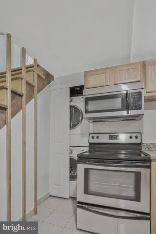 a stove top oven sitting inside of a kitchen