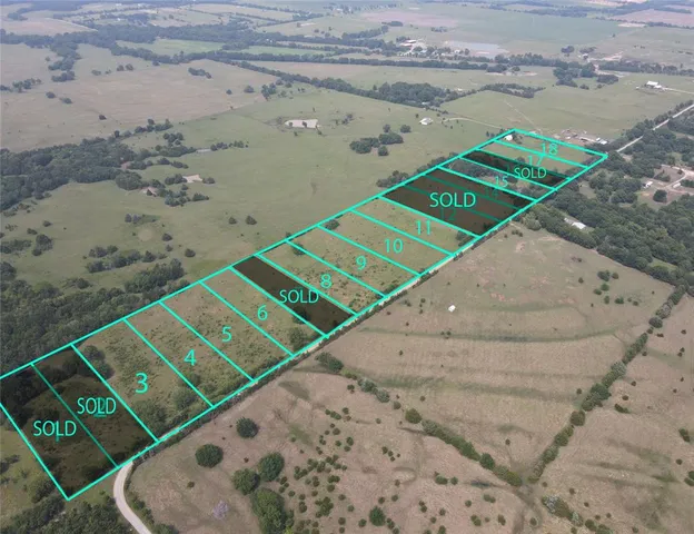 a view of a tennis court with a view of the city
