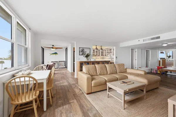 a living room with furniture wooden floor and a large window