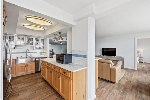 a kitchen with stainless steel appliances granite countertop a sink and a stove top oven
