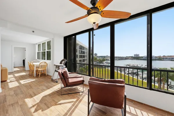 a living room with furniture and floor to ceiling windows