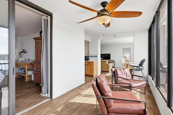 a view of a dining room with furniture and a chandelier fan