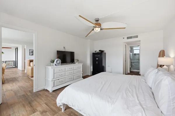 a bedroom with a bed and a flat screen tv