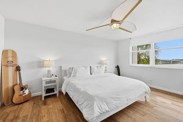 a bedroom with a bed and wooden floor