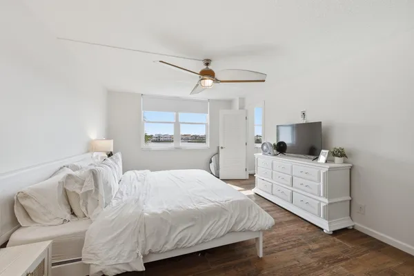 a bedroom with a bed and a flat screen tv