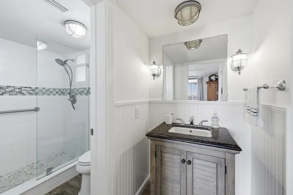 a bathroom with a sink vanity and a mirror