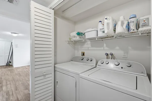 a view of washer and dryer with kitchen countertops