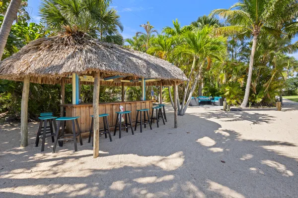 a view of a patio with a table and chairs under an umbrella