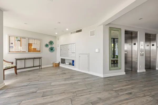 a view of a livingroom with wooden floor and furniture