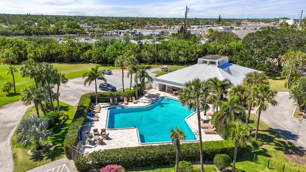 an aerial view of a house with yard swimming pool and outdoor seating