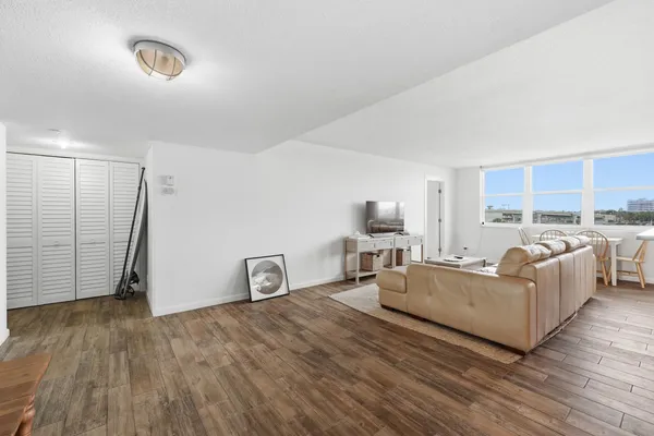 a living room with furniture and a wooden floor