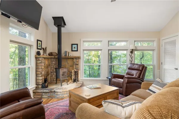 a living room with furniture large window and flat screen tv