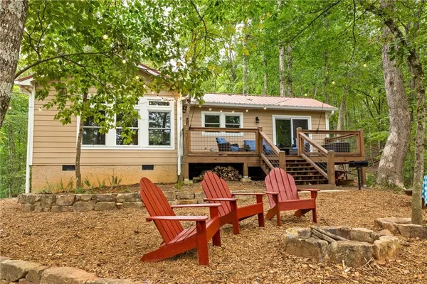a view of a house with backyard sitting area