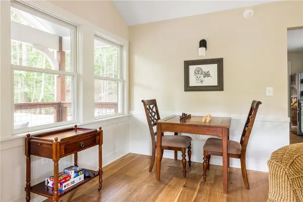 a view of a dining room with furniture window and wooden floor