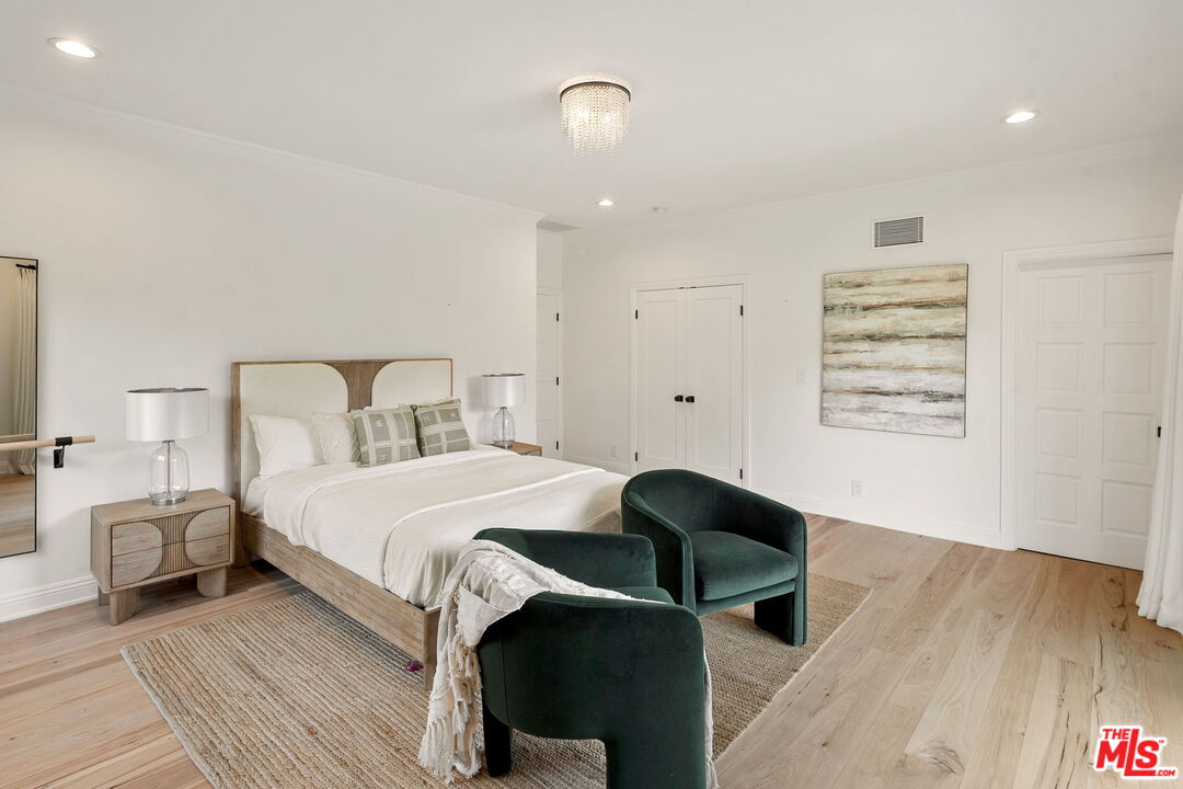 280 Homewood Road Los Angeles, CA 90049 - Photo 34 of 53 a bedroom with a bed and a mirror