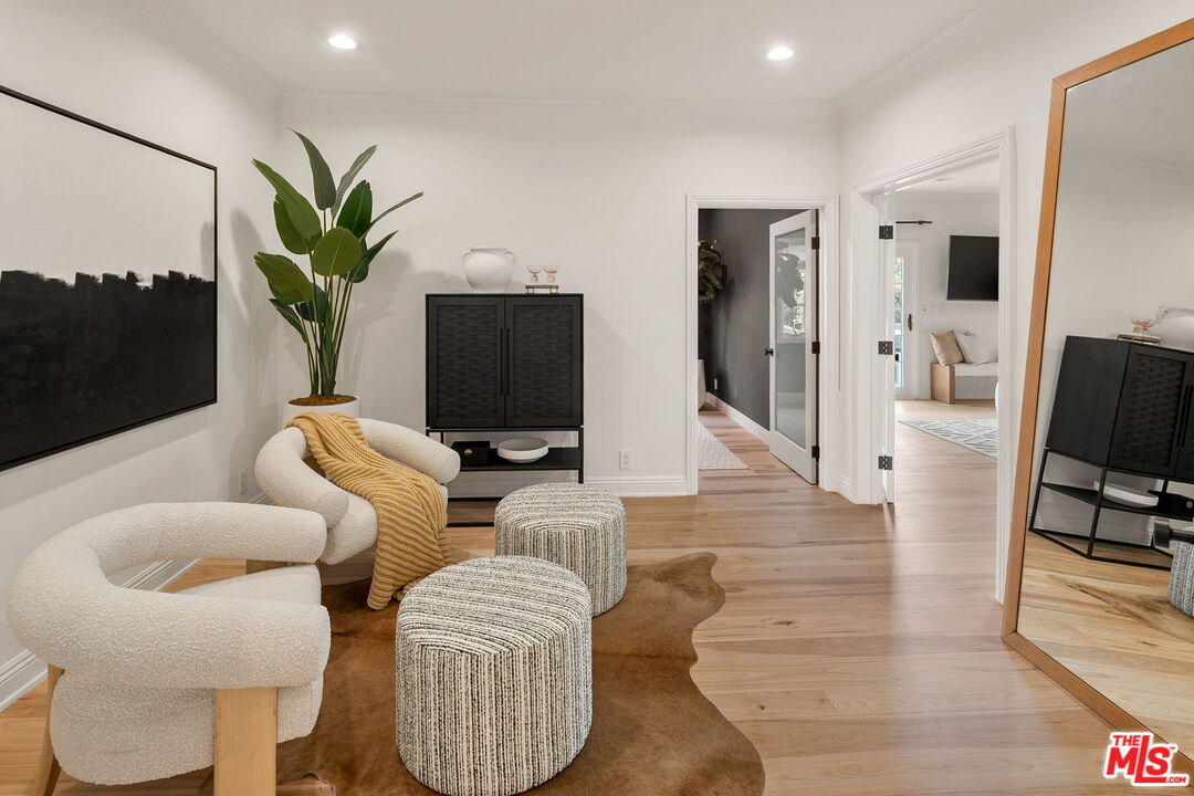 280 Homewood Road Los Angeles, CA 90049 - Photo 39 of 53 a living room with furniture a flat screen tv and a potted plant