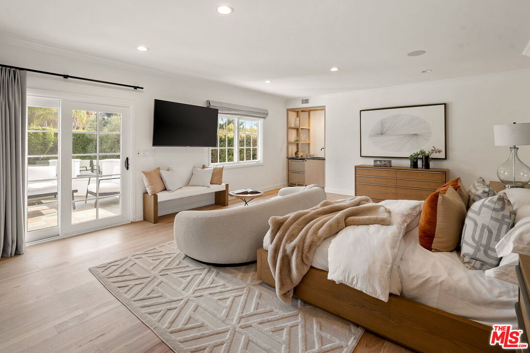 280 Homewood Road Los Angeles, CA 90049 - Photo 42 of 53 a bedroom with a large bed and a flat screen tv