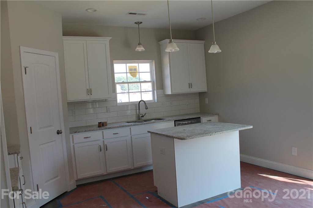 4813 Stack Road Monroe, NC 28112 - Photo 4 of 9 a kitchen with a sink stove and cabinets