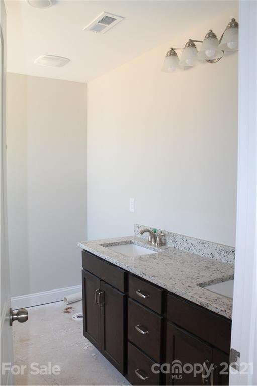 4813 Stack Road Monroe, NC 28112 - Photo 9 of 9 a bathroom with a granite countertop sink and a mirror