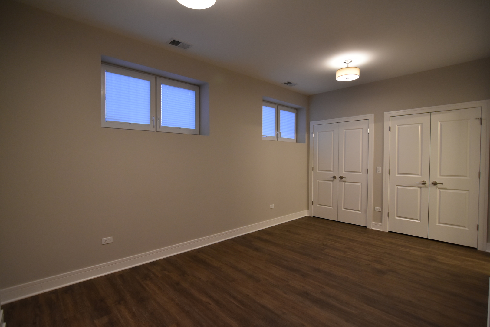 Undisclosed Address Chicago, IL 60613 - Photo 12 of 17 a view of an empty room with wooden floor and a window