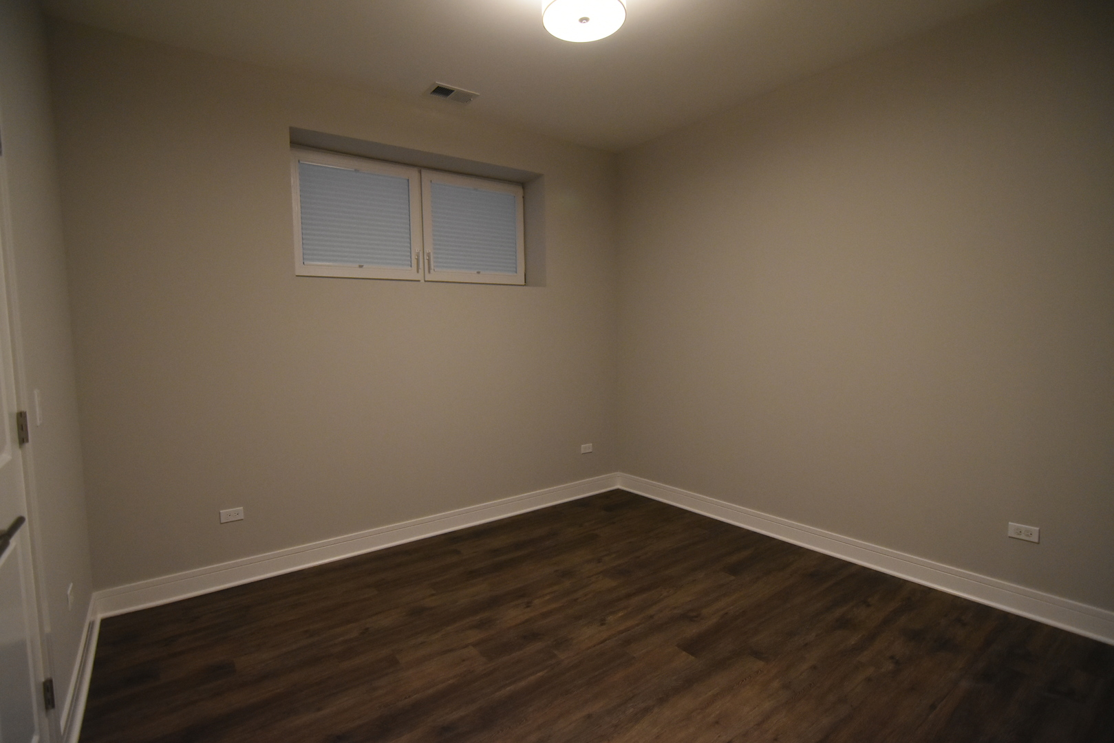 Undisclosed Address Chicago, IL 60613 - Photo 8 of 17 a view of an empty room with wooden floor and a window