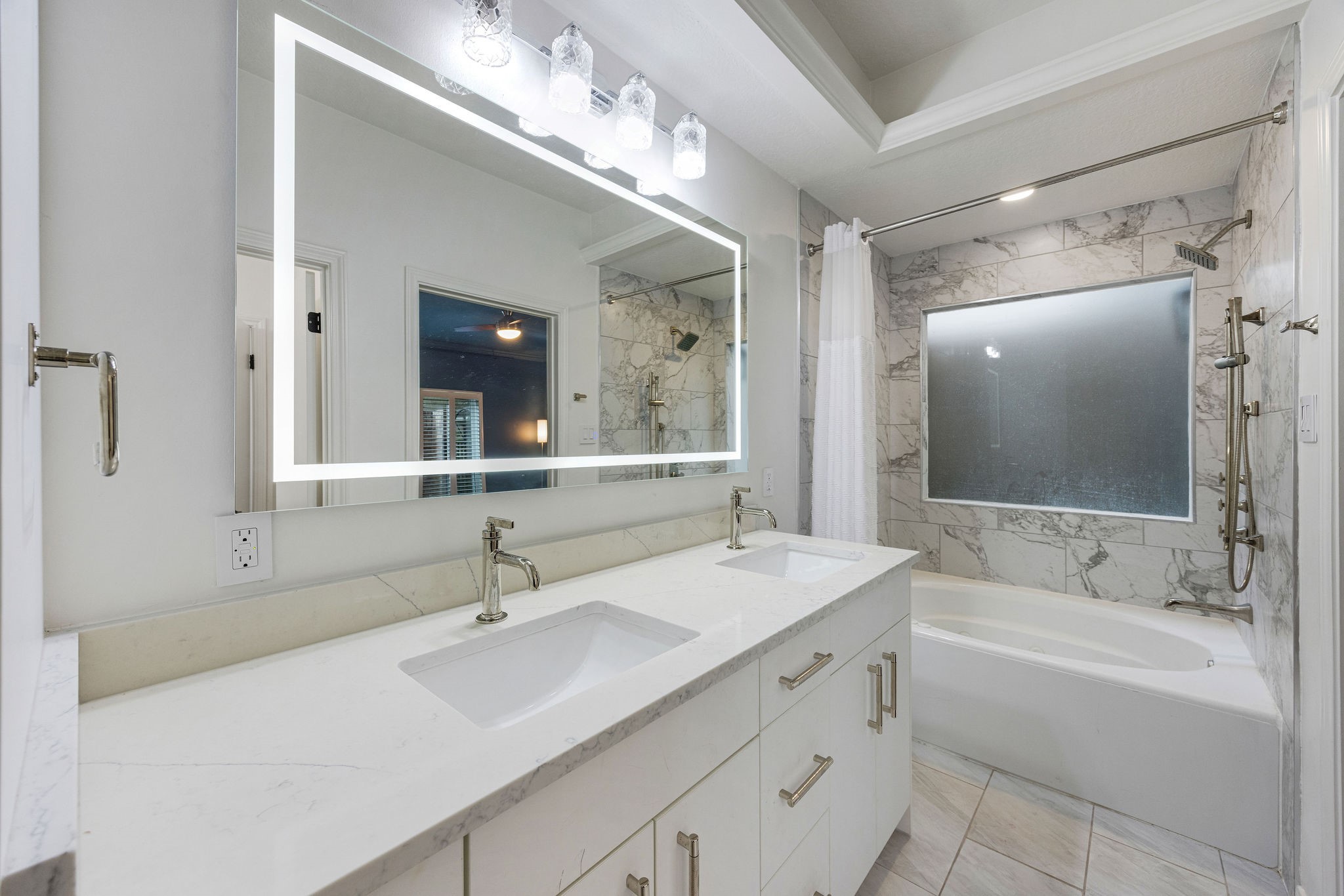 727 Bunker Hill Road, Unit 26 Houston, TX 77024 - Photo 15 of 25 The primary ensuite was updated with new cabinetry, counter tops, tile to the ceiling in the shower/tub and new tiles on the floors. Note the LED mirrors and lighting, giving you the perfect set up for your morning routine.