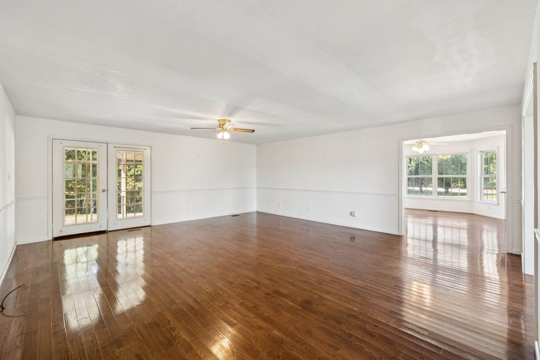 240 Hurst Road Hohenwald, TN 38462 - Photo 13 of 76 an empty room with wooden floor and windows