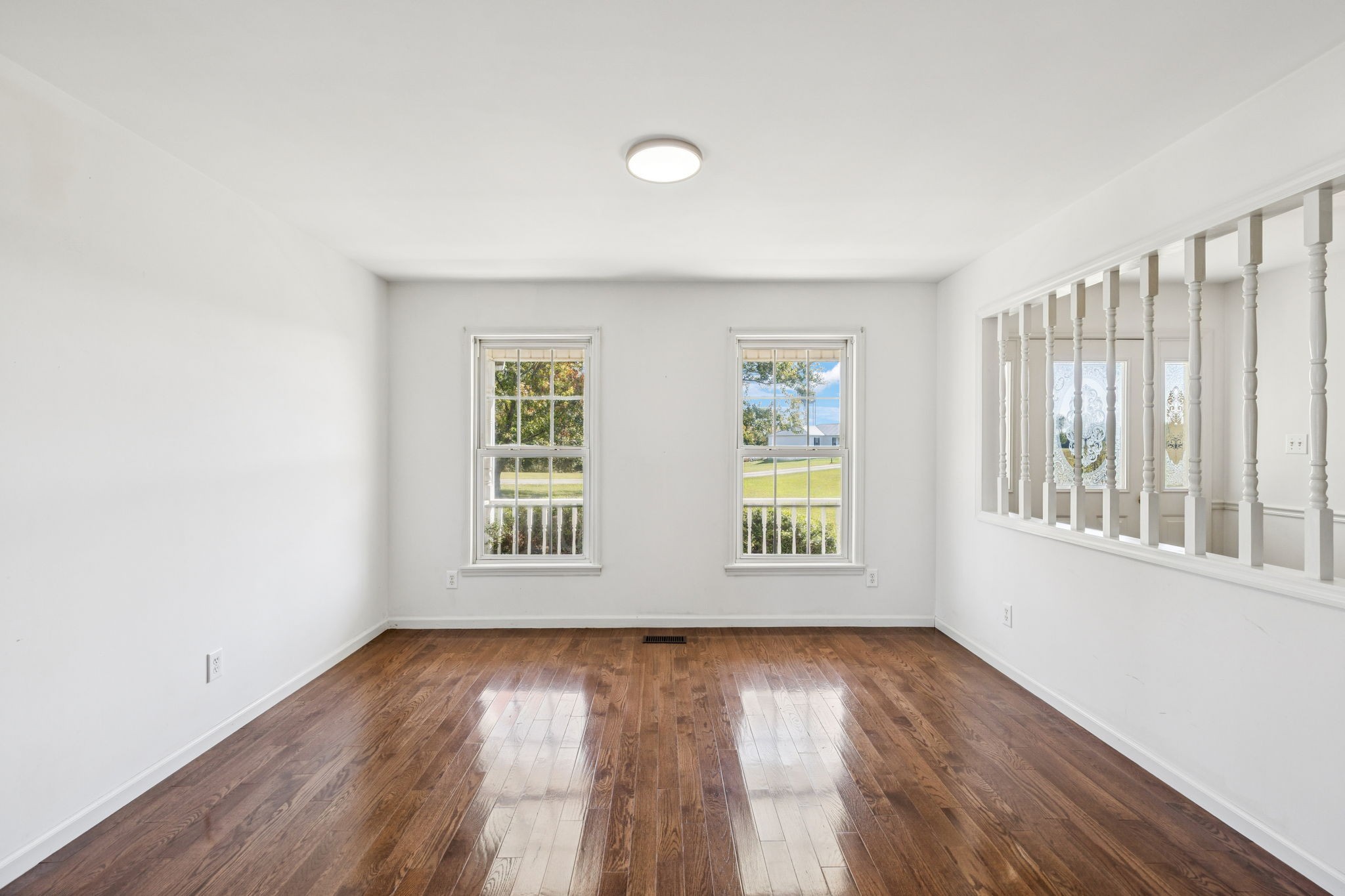 240 Hurst Road Hohenwald, TN 38462 - Photo 16 of 76 an empty room with wooden floor and windows