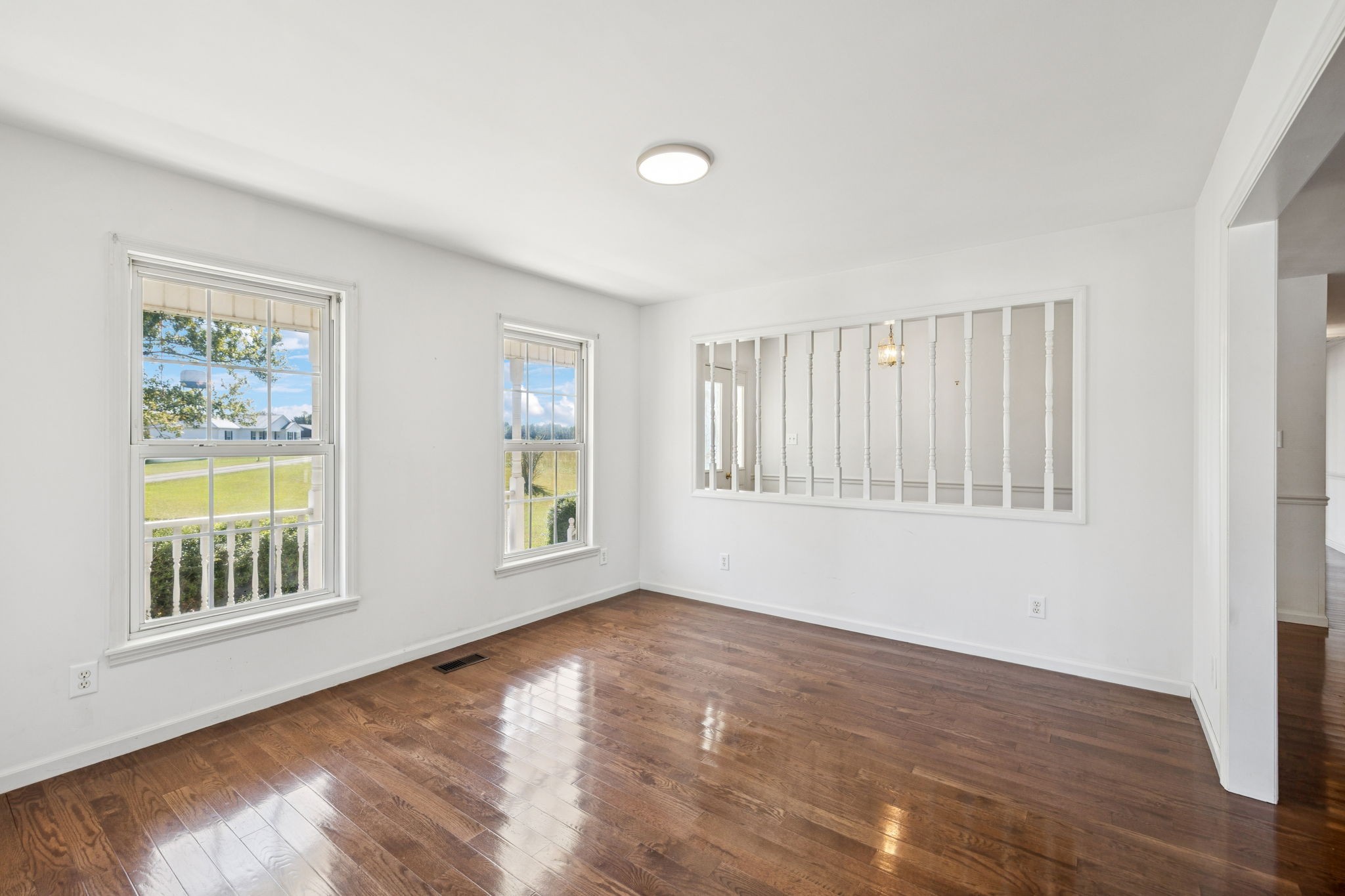 240 Hurst Road Hohenwald, TN 38462 - Photo 17 of 76 a view of an empty room with wooden floor and a window