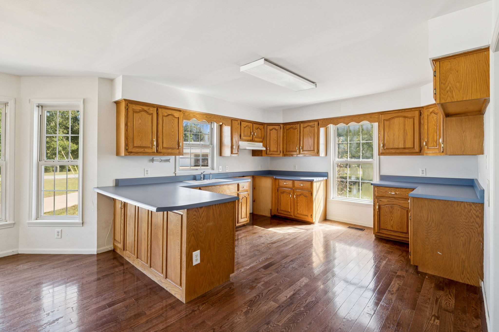 240 Hurst Road Hohenwald, TN 38462 - Photo 19 of 76 a kitchen with stainless steel appliances granite countertop wooden floors and view living room
