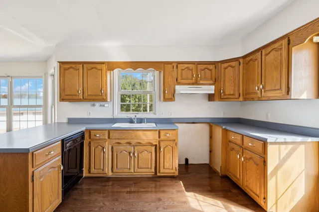 a view of kitchen with cabinets and wooden floor