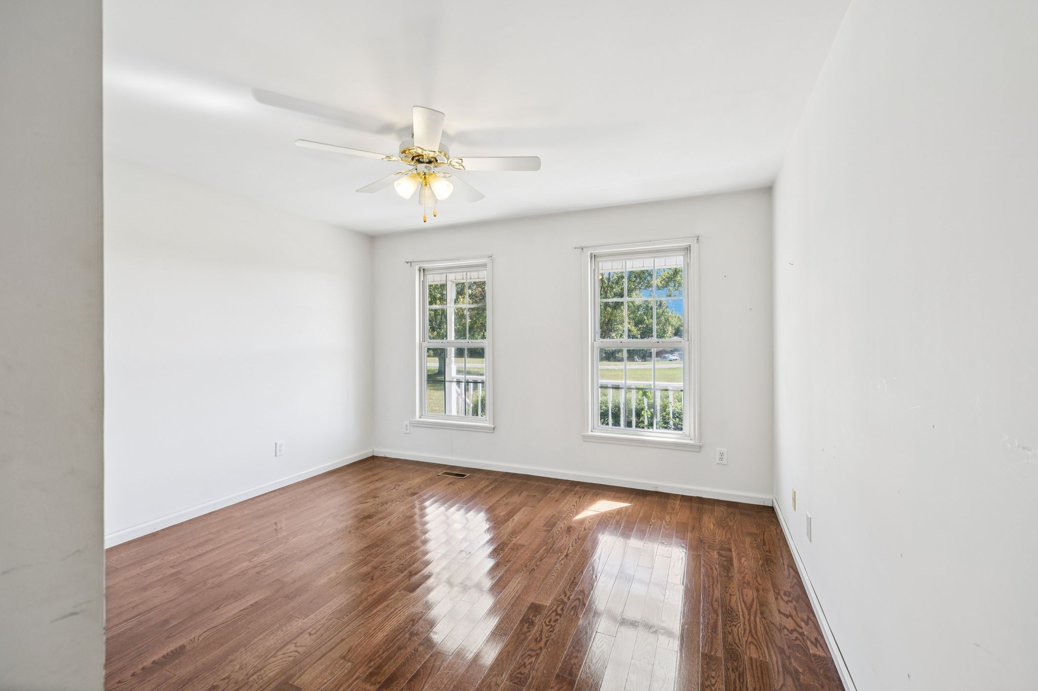 240 Hurst Road Hohenwald, TN 38462 - Photo 30 of 76 an empty room with wooden floor chandelier and windows