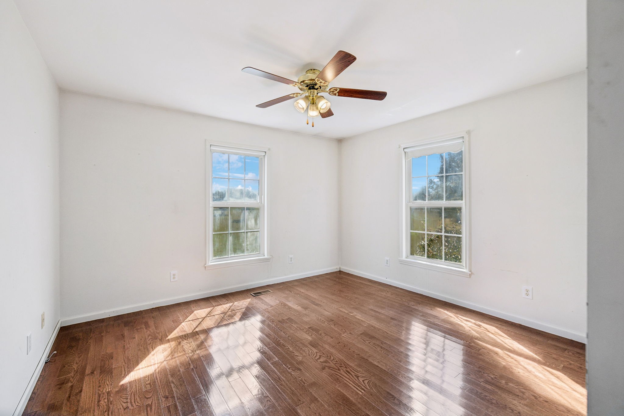240 Hurst Road Hohenwald, TN 38462 - Photo 32 of 76 a view of an empty room with window and wooden floor
