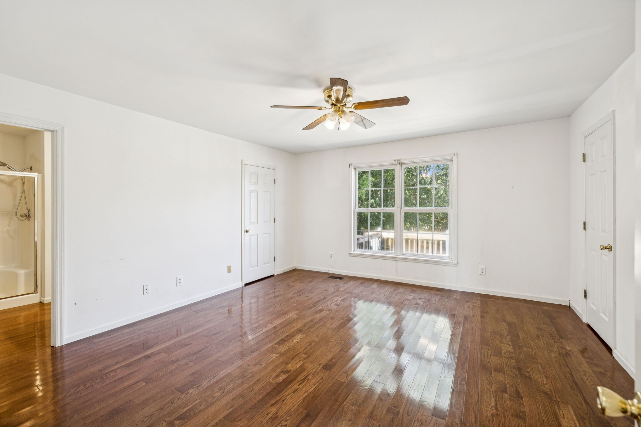 240 Hurst Road Hohenwald, TN 38462 - Photo 34 of 76 an empty room with wooden floor and windows