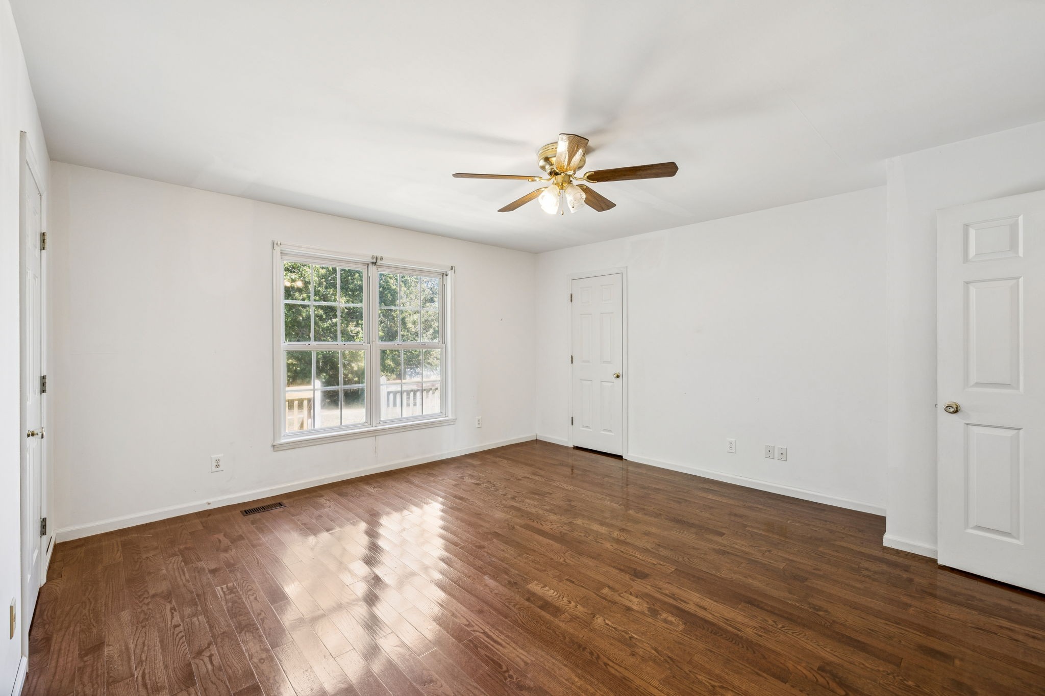 240 Hurst Road Hohenwald, TN 38462 - Photo 36 of 76 a view of empty room with wooden floor and fan