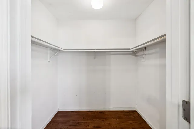 a view of a house next to a big yard with large trees