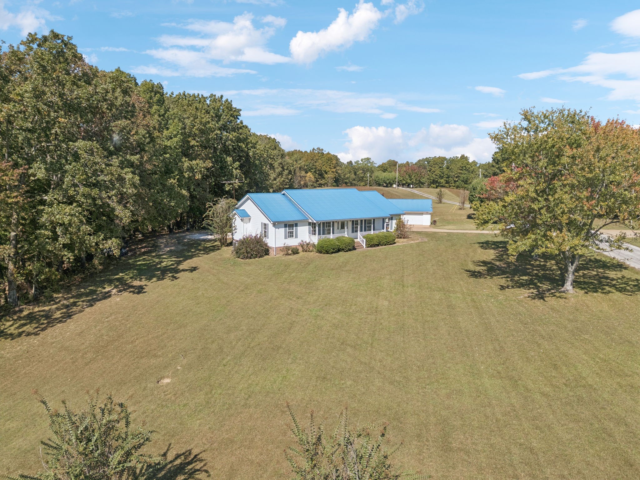 240 Hurst Road Hohenwald, TN 38462 - Photo 55 of 76 a view of a lake with a building in the background