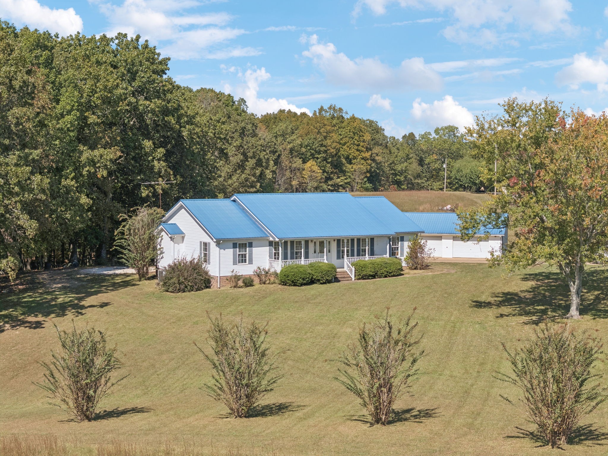 240 Hurst Road Hohenwald, TN 38462 - Photo 56 of 76 a view of a house next to a big yard with large trees