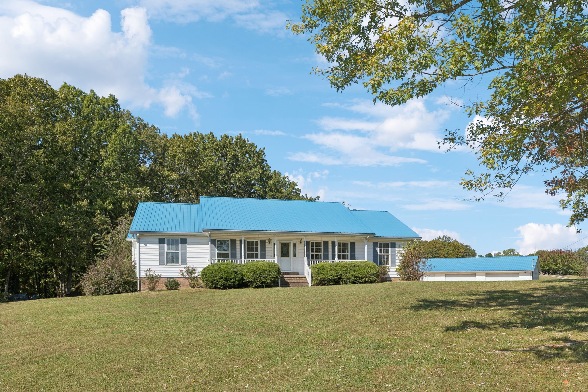 240 Hurst Road Hohenwald, TN 38462 - Photo 7 of 76 a view of a yard in front of a house with a big yard