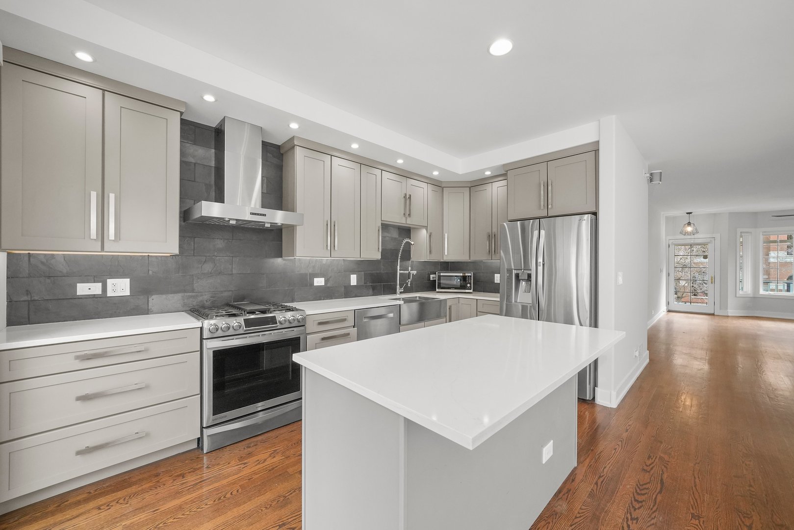 1026 West Monroe Street Chicago, IL 60607 - Photo 11 of 30 a kitchen with stainless steel appliances a white stove top oven and refrigerator