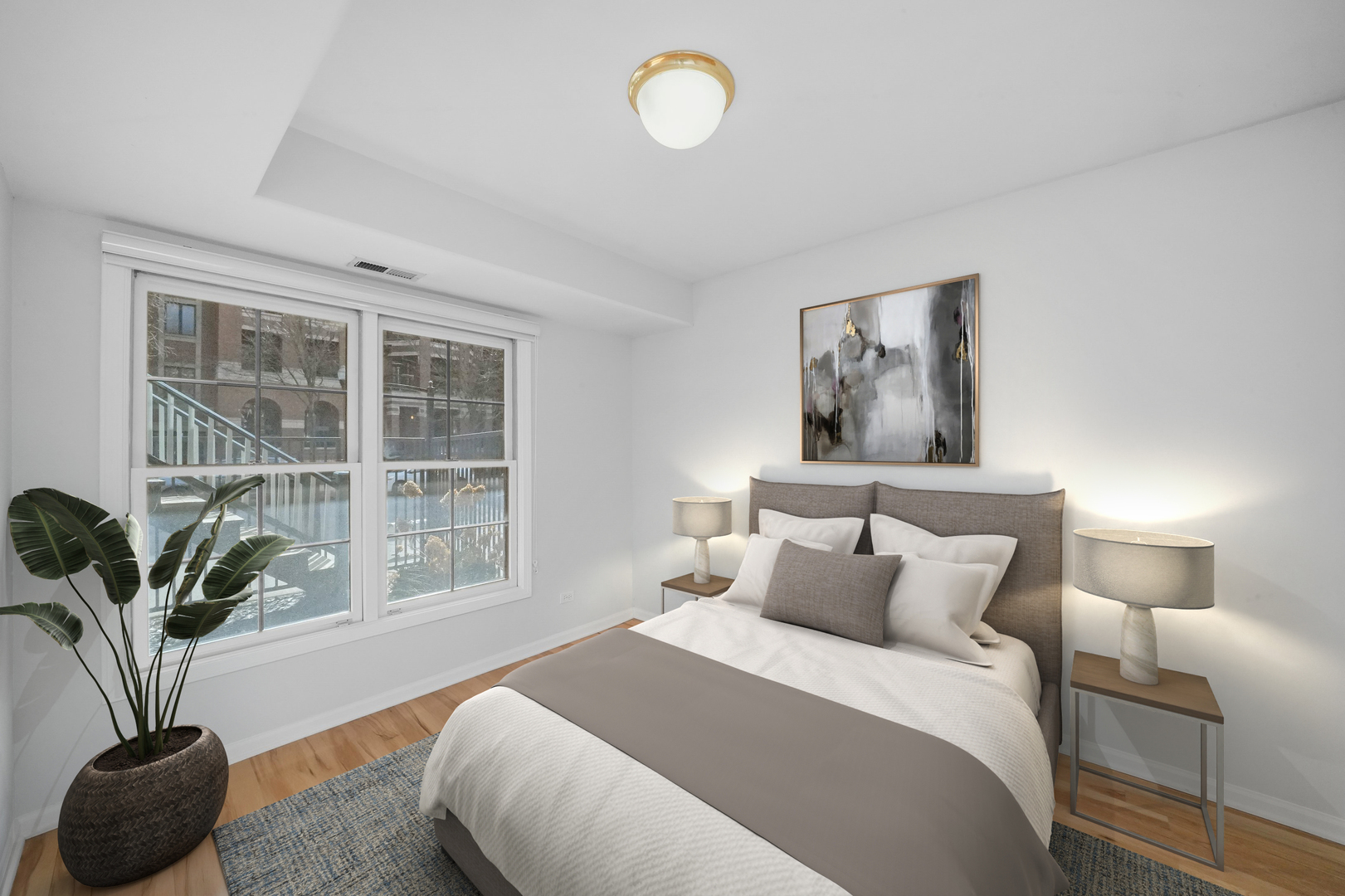 1026 West Monroe Street Chicago, IL 60607 - Photo 21 of 30 a bedroom with a bed and a potted plant